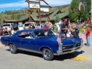 A thumb nail view of Grand Lake, Colorado during Constitution Week in September looking at a vintage blue car rolling down Grand Avenue in the parade; click here to open a window with a larger picture.
